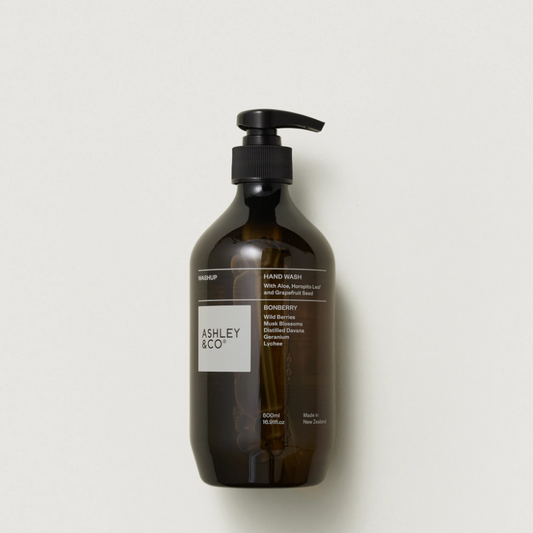Ashley & Co hand wash in an amber glass bottle with a black pump dispenser, shown against a plain off-white background.