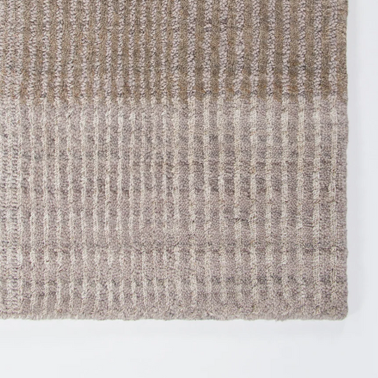 Shop the Baya Bedrock Outdoor Rug at Comber and Comber. A textured recycled PET rug for sheltered outdoor living. Available in Sand, Claret and Zinc.