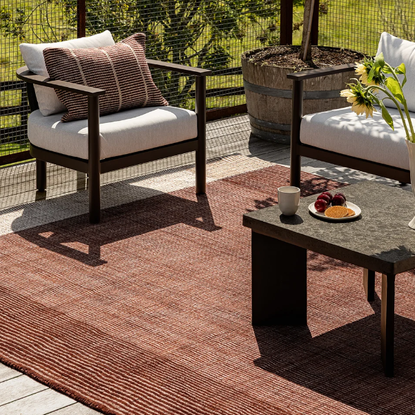 Shop the Baya Bedrock Outdoor Rug at Comber and Comber. A textured recycled PET rug for sheltered outdoor living. Available in Sand, Claret and Zinc.