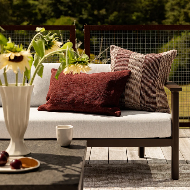Shop the Baya Tide Outdoor Cushion at Comber and Comber. Handwoven from recycled PET with a textured linear design. Available in multiple colours.