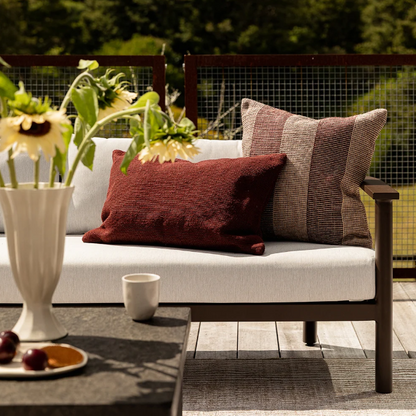Shop the Baya Tide Outdoor Cushion at Comber and Comber. Handwoven from recycled PET with a textured linear design. Available in multiple colours.