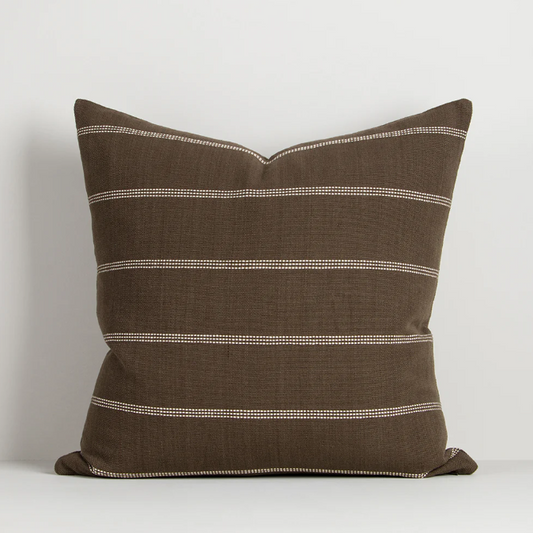 A refined jacquard-woven cushion collection featuring subtle linear detailing and rich, earthy colourways designed to bring warmth, texture, and timeless style to contemporary interiors.