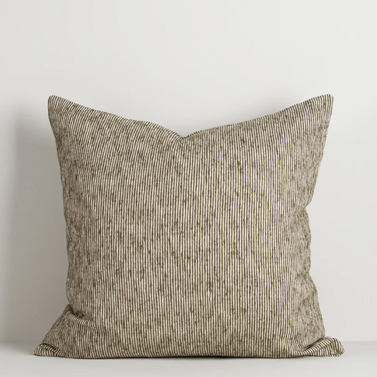 A beautifully textured cotton cushion featuring a subtle pinstripe weave and earthy colour palette, designed to bring warmth, depth, and effortless layering to contemporary interiors.