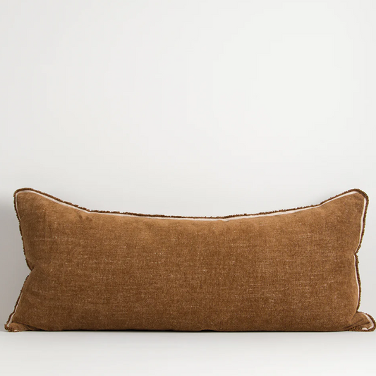 A luxurious cotton-linen chenille lodge cushion featuring a soft velvety texture, refined border detailing, and rich earthy colourways designed to bring warmth, comfort, and sophistication to contemporary interiors.