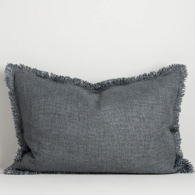 The Dover 40x60cm lumbar cushion features a thick woven texture in slate blue with soft fringing, adding warmth and understated style to any space.