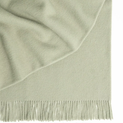 Shop the Nevis lambswool throw 130x200cm – made from 100% New Zealand wool with a soft, thick texture and tassel fringe, perfect for cosy living and gifting.