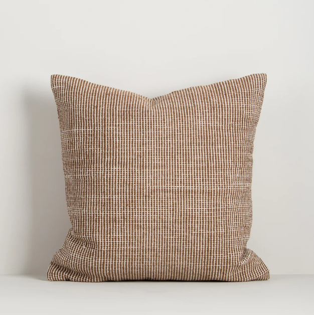 Shop the Baya Dune Outdoor Cushion at Comber and Comber. Handwoven from recycled PET with a textured two-tone design, perfect for stylish outdoor living.