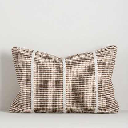 Shop the Baya Shore Outdoor Cushion at Comber and Comber. A handwoven recycled PET lumbar cushion with a timeless linear design, available in multiple colours.