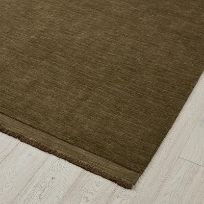 Deep olive rug on a light wood floor. 2x3m 3x4m. 100% NZ wool