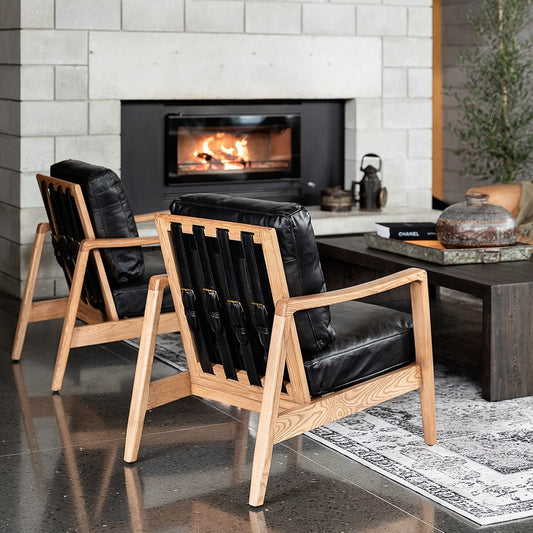 The Reid Armchair blends contemporary design with premium comfort, featuring hand-dyed leather, a sculptural strap backrest with brass buckle detail, and a supportive foam and feather cushion combination.