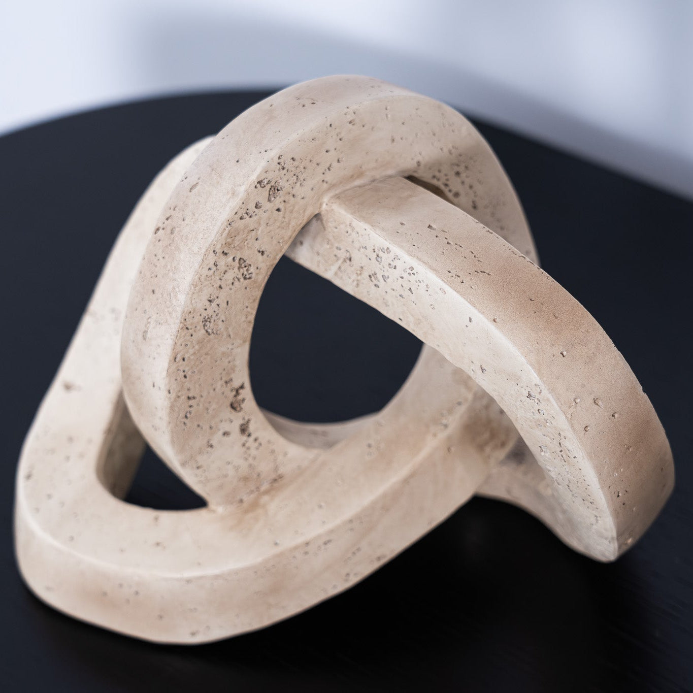 The Marley Decorative Link in resin features an interlocking sculptural design, perfect for adding modern style and texture to tables, shelves, or layered displays.