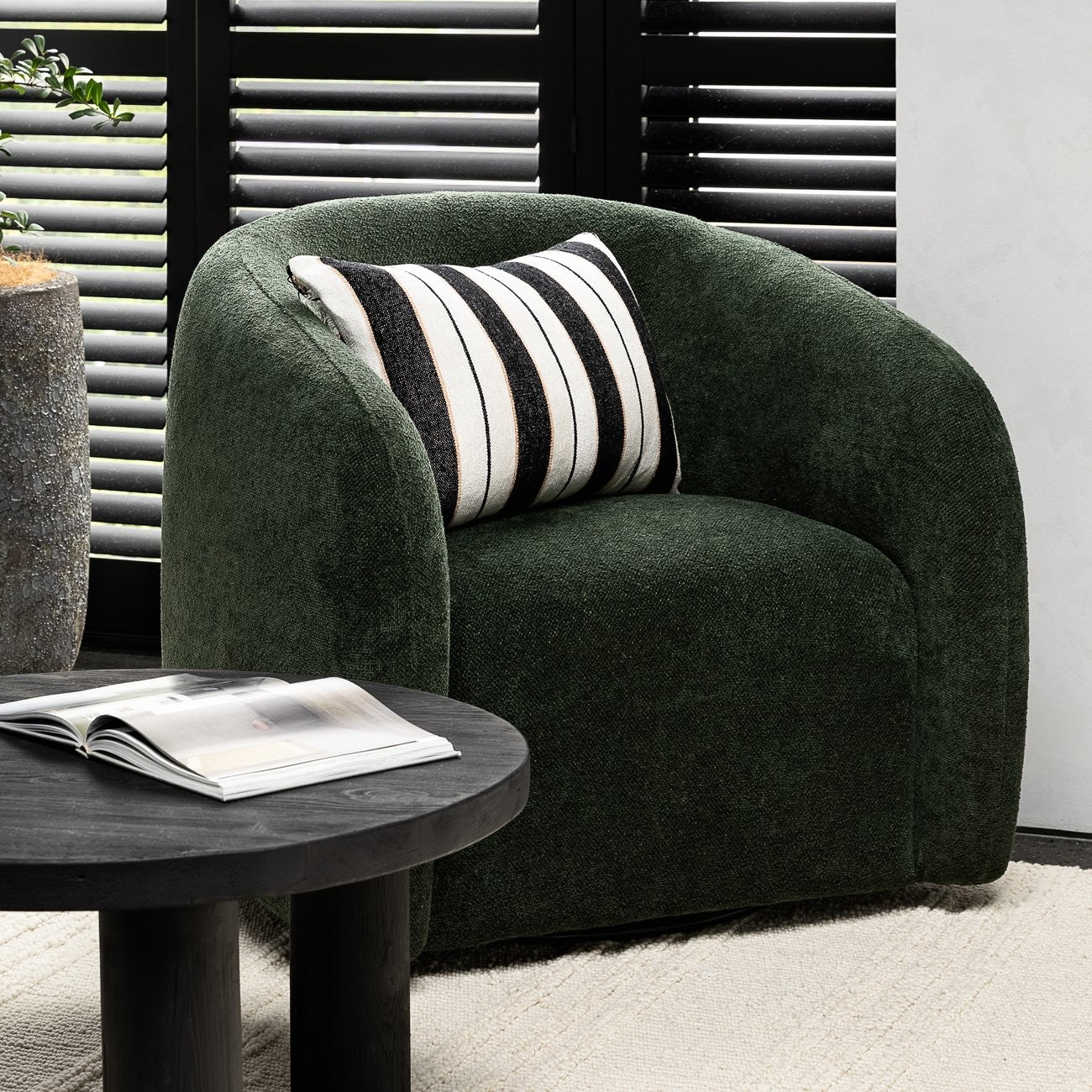 A sculptural swivel chair with deep comfort, tailored curves, and a timeless, versatile design.