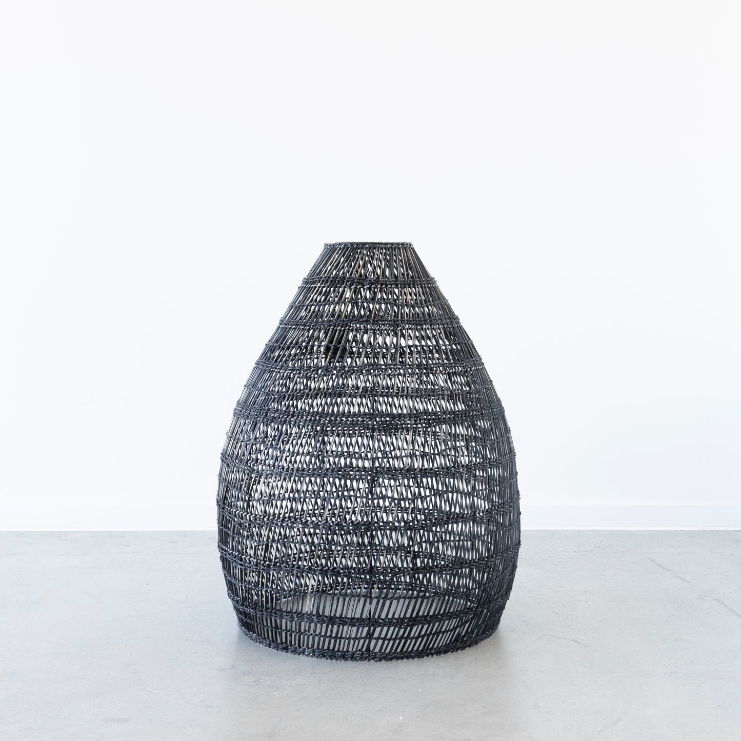 Black wash rattan pendant light hanging in living room