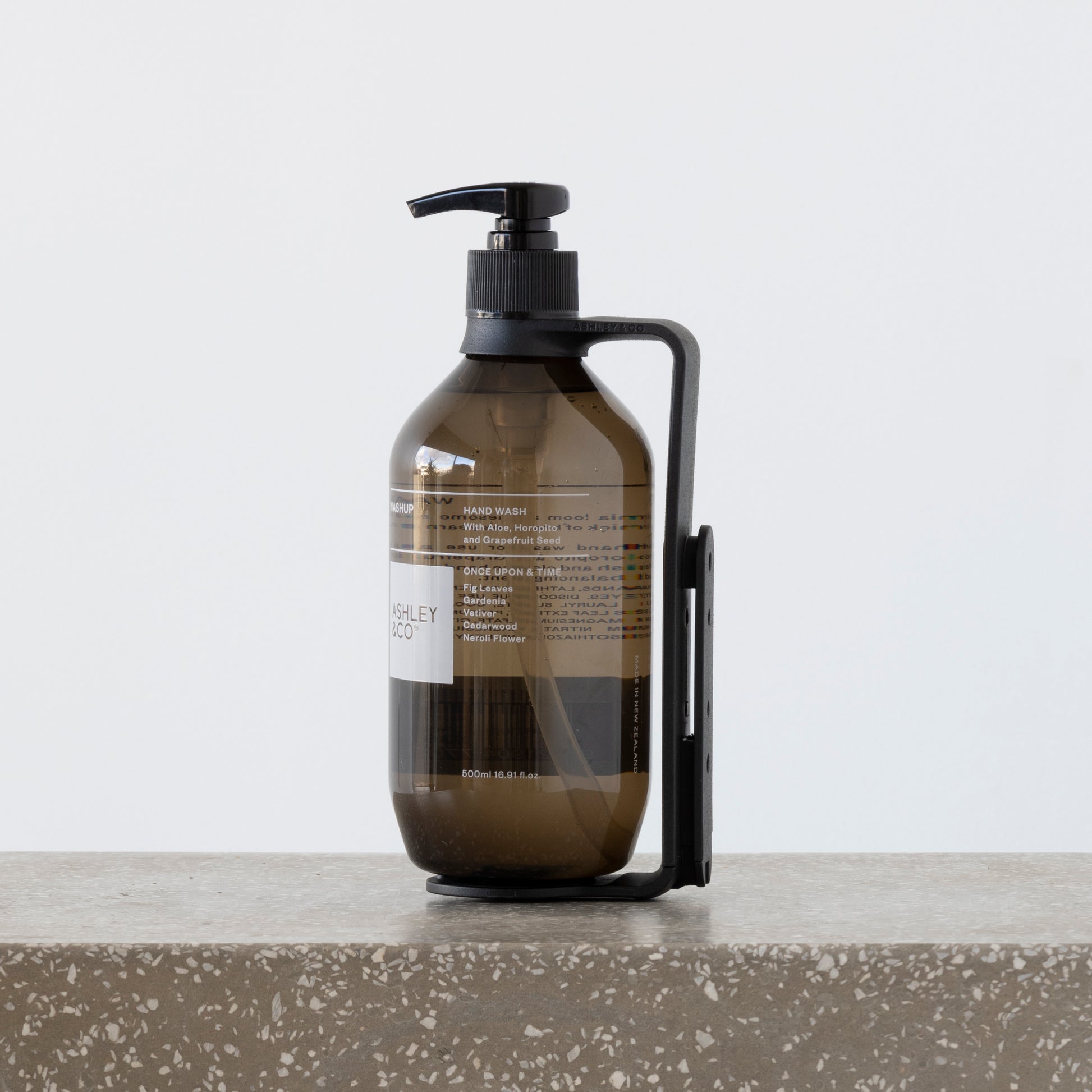 Close-up of Hold Me cradling 500ml wash and body bottles