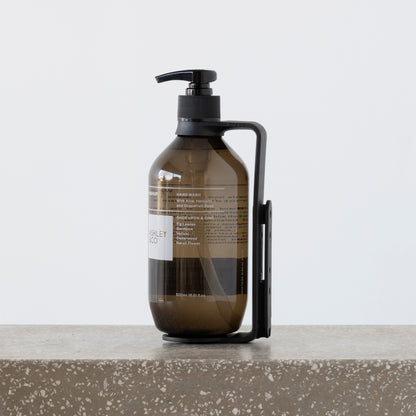 Close-up of Hold Me cradling 500ml wash and body bottles