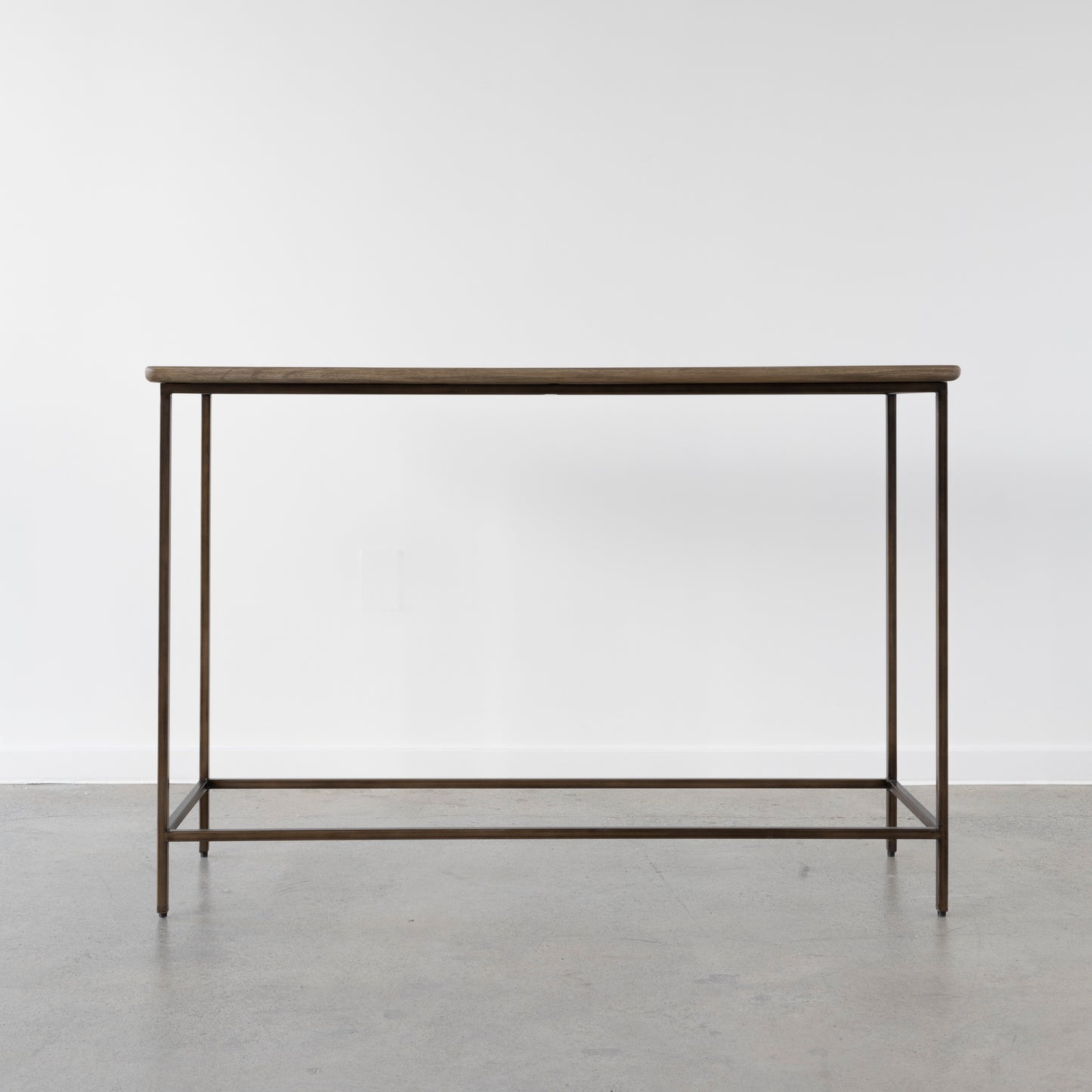 Valour Console Table in vintage dark brass finish in modern hallway