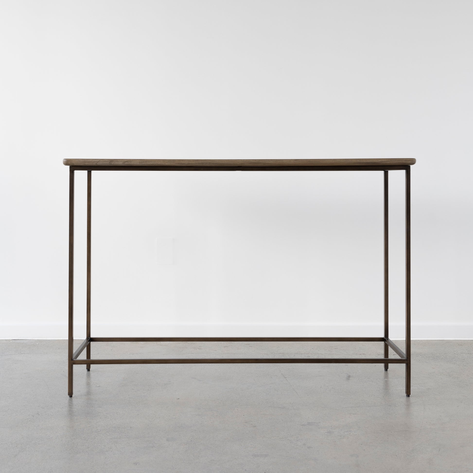 Valour Console Table in vintage dark brass finish in modern hallway