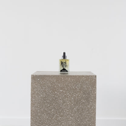 Becca Body Oil bottle on wooden surface with natural oils