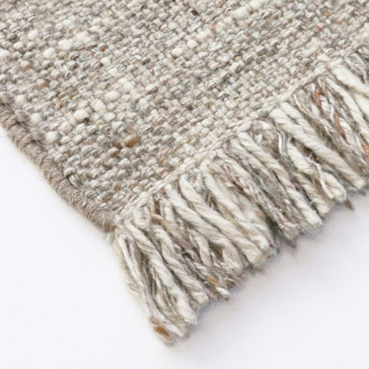 Tonal plaid floor rug with fringed edges