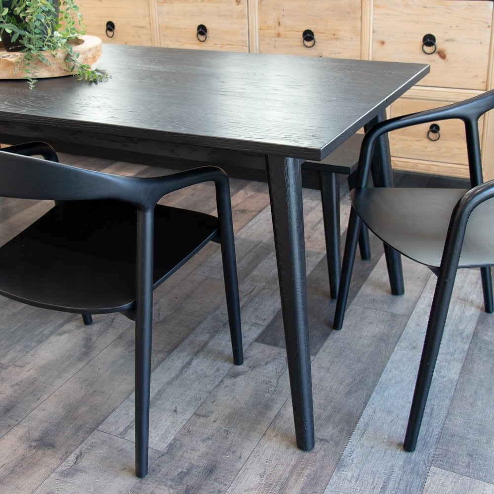 Scandinavian-style oak dining table with matte black finish